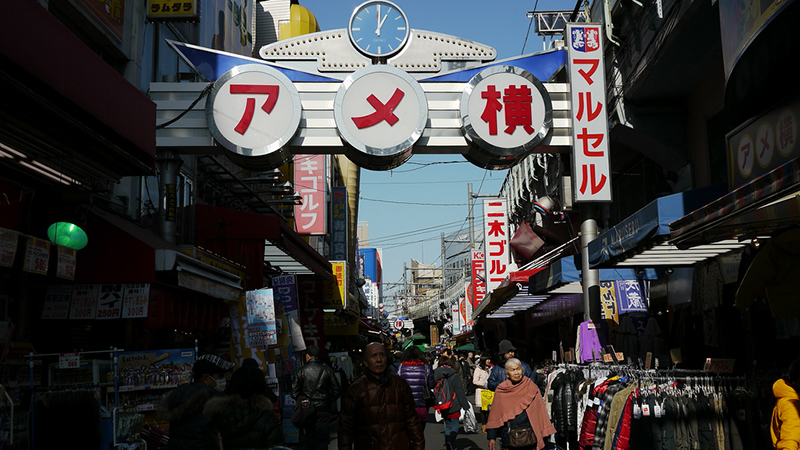 crowded japanese street red and white sign